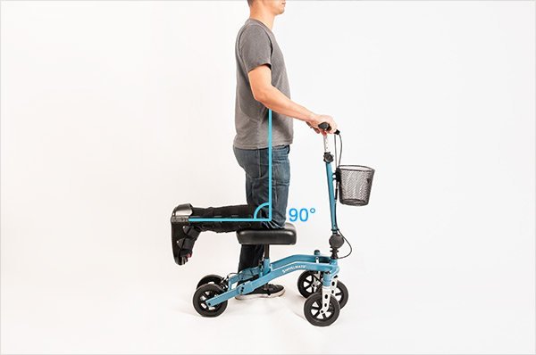 A modern knee scooter stands ready for adjustment in a bright, professional studio setting.