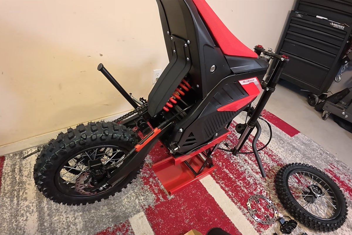 Essential mechanic tools including a torque wrench and sockets for dirt bike assembly.