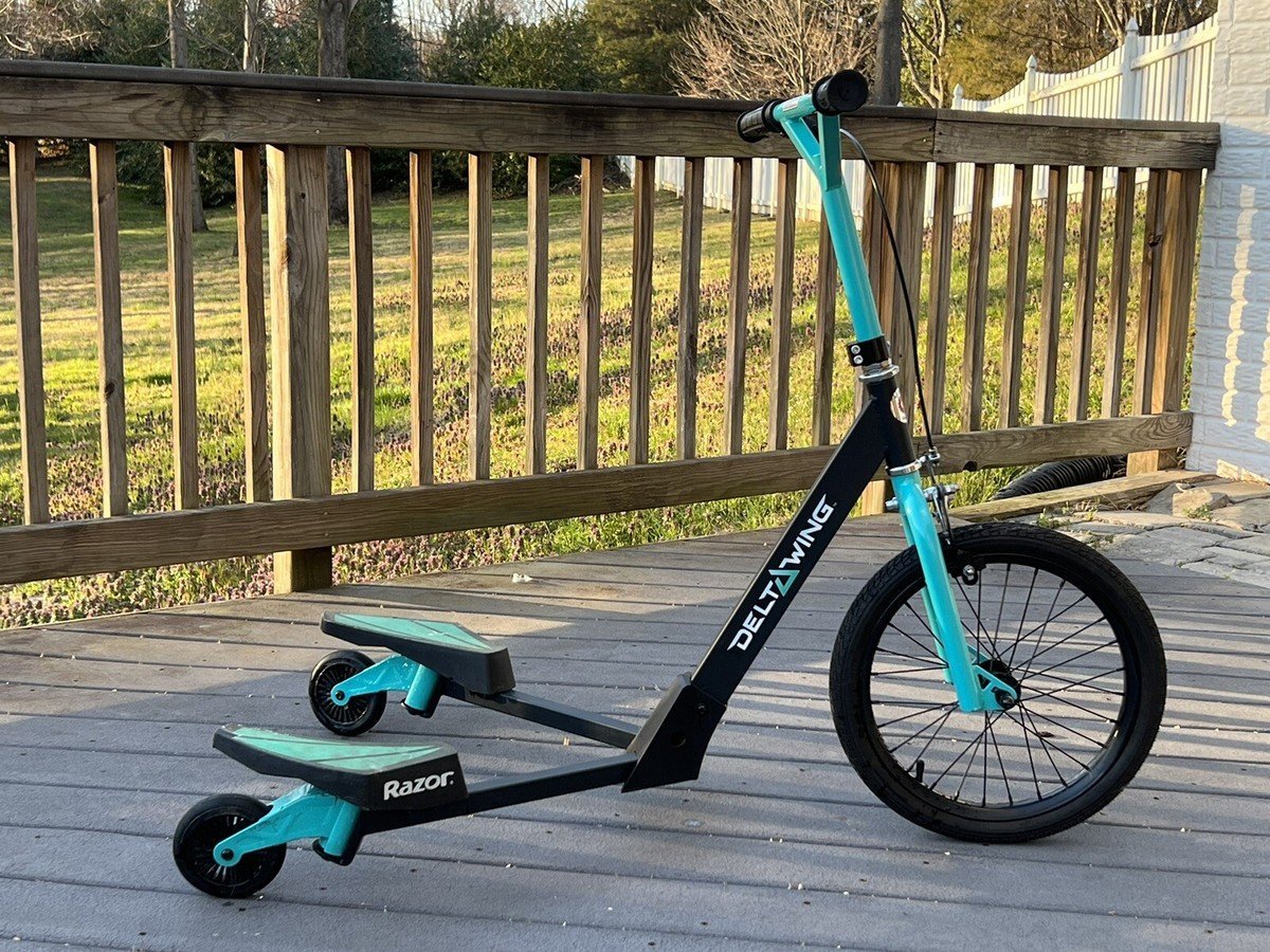 Testing the stability of the handlebars on an assembled razor scooter.