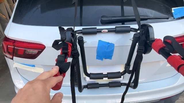 Essential tools for installing a bike rack laid out on a wooden workbench.