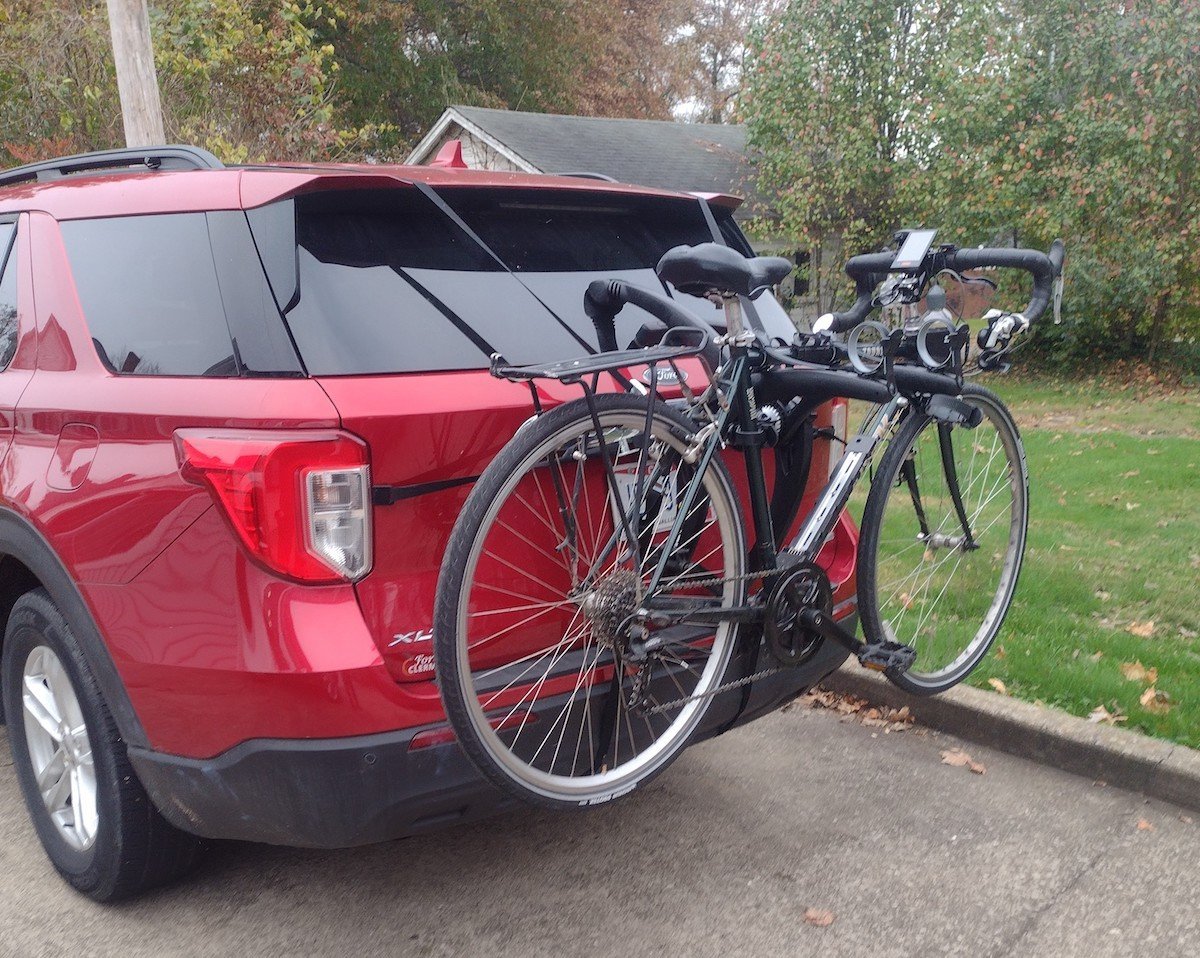 A close-up of a secure bike rack hitch connection on an SUV.