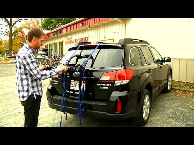 A secure hitch-mounted bike rack attached to the rear of a modern SUV.