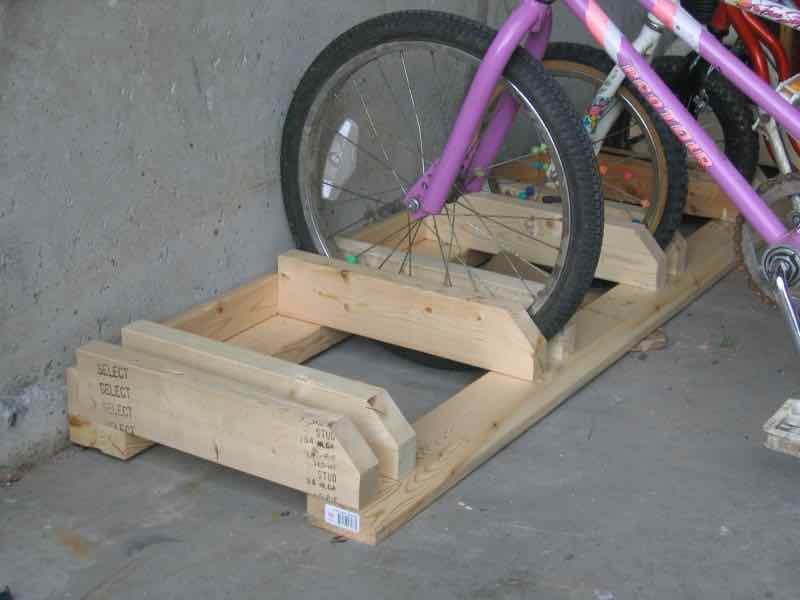 A person reviewing construction plans in a workshop for building a bike rack.