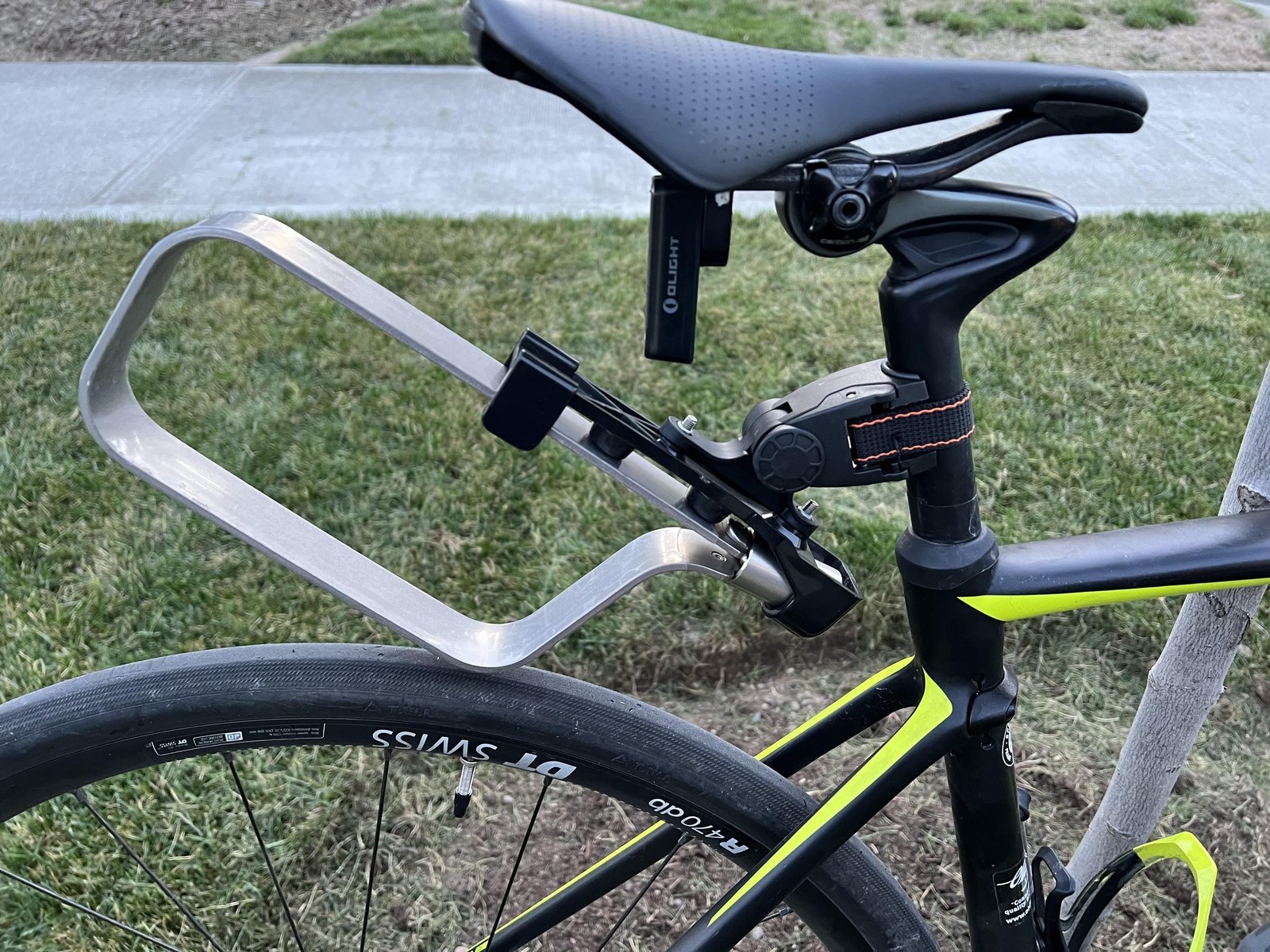A securely mounted cable lock on a bicycle frame with ample clearance for pedaling.
