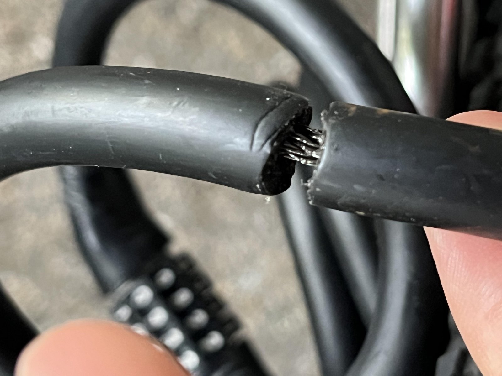 A dirty bike lock cylinder with a key struggling to turn inside it.