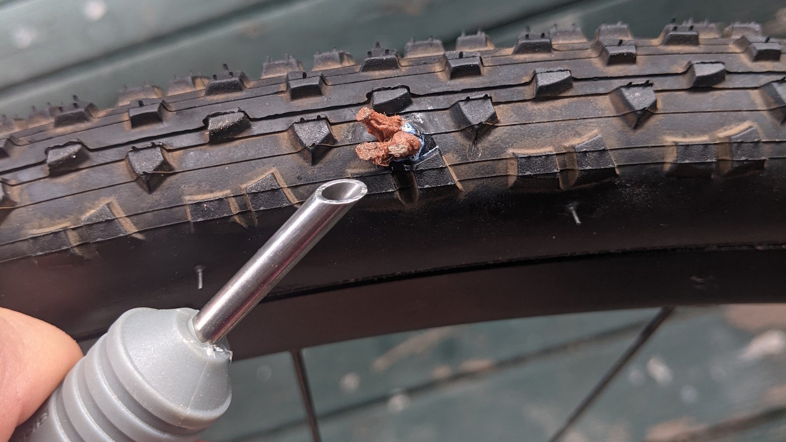 Applying a radial patch to the inside of a tubeless bike tire.