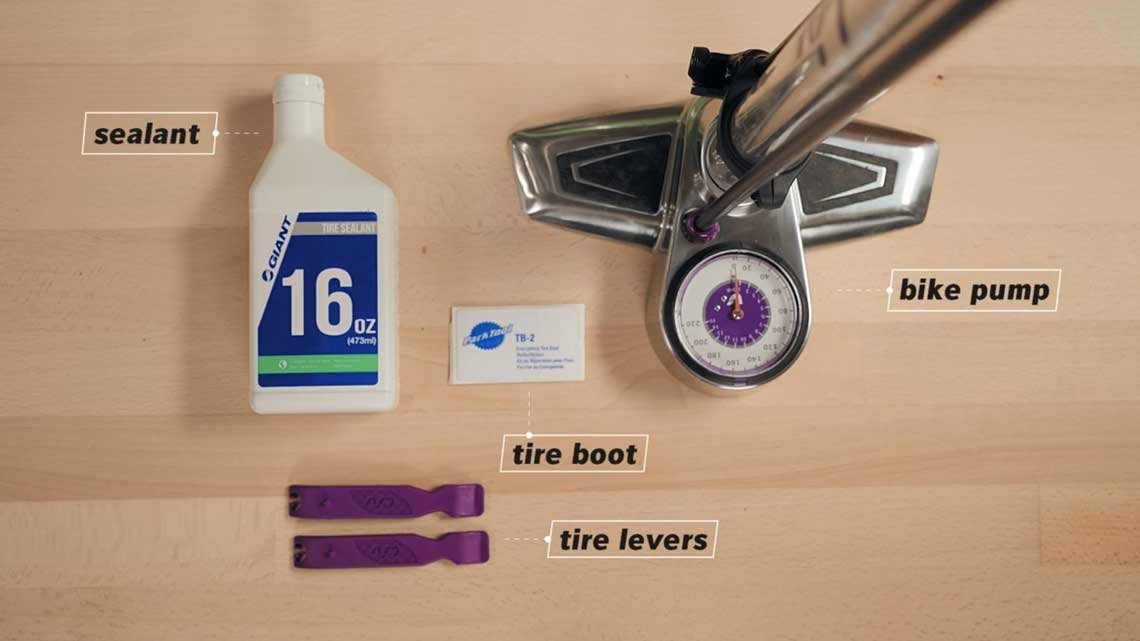 Various bike maintenance tools arranged neatly for repairing tubeless tires.