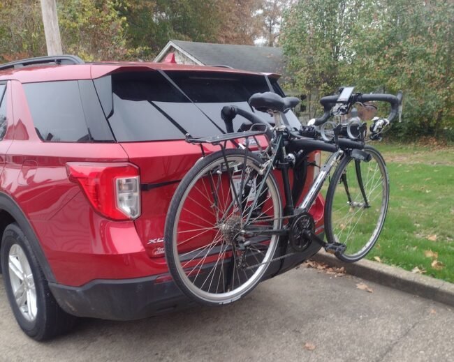 A secure mountain bike rack attached to the rear of a modern car.