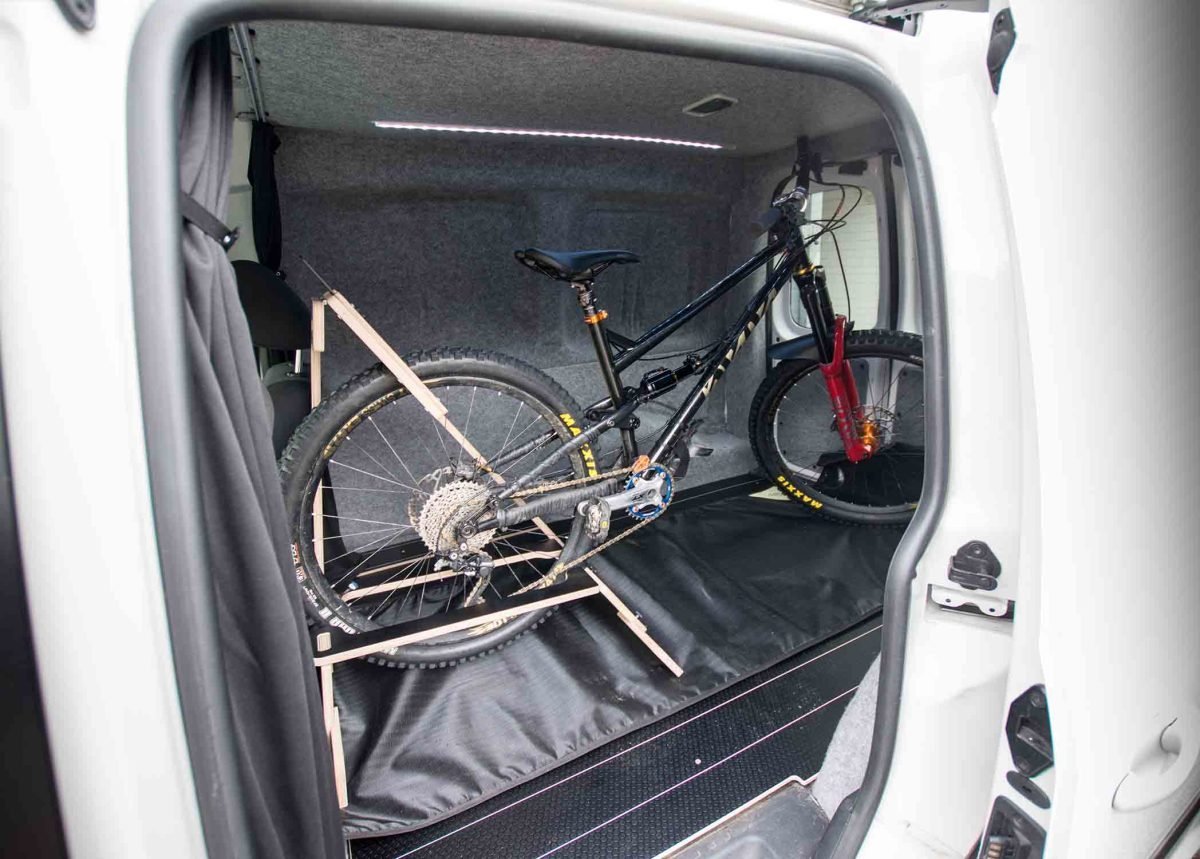 Essential tools for installing a bike rack neatly arranged on a workbench.