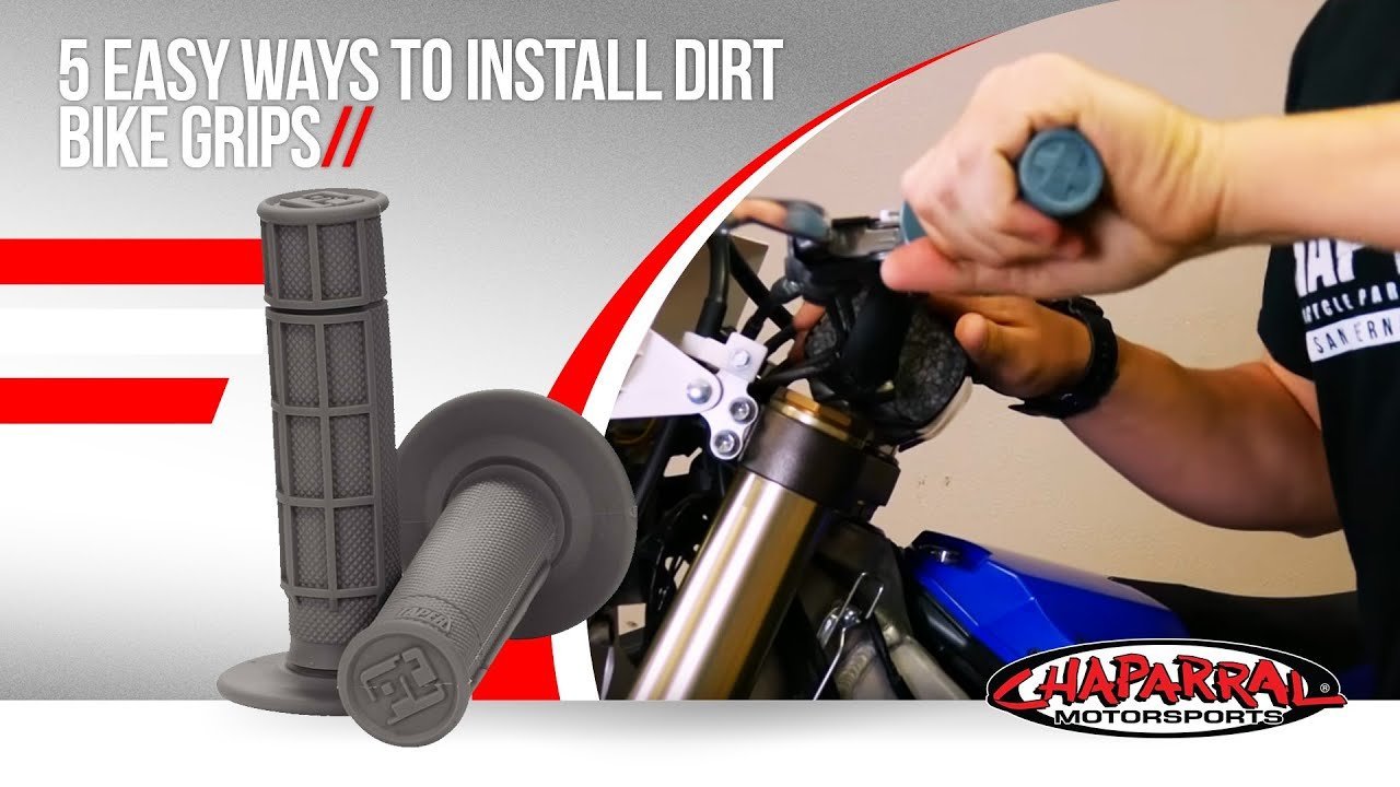 Professional tools for dirt bike handlebar installation arranged on a workbench mat.