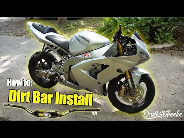 Checking the throttle response on a dirt bike after handlebar installation.