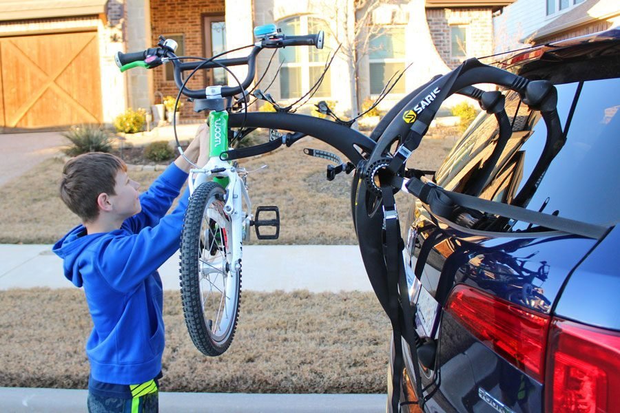 Necessary tools and accessories for installing a Saris bike rack on a vehicle.