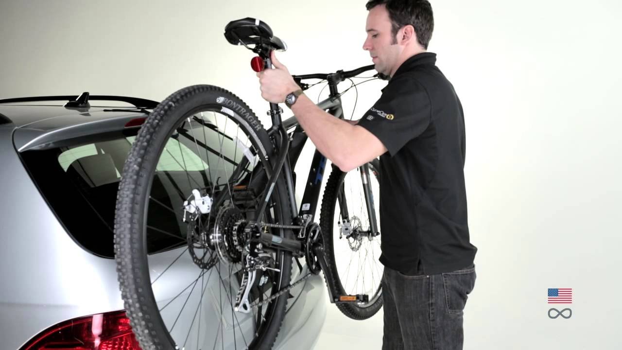 Checking the stability of a securely installed Saris bike rack on a car.