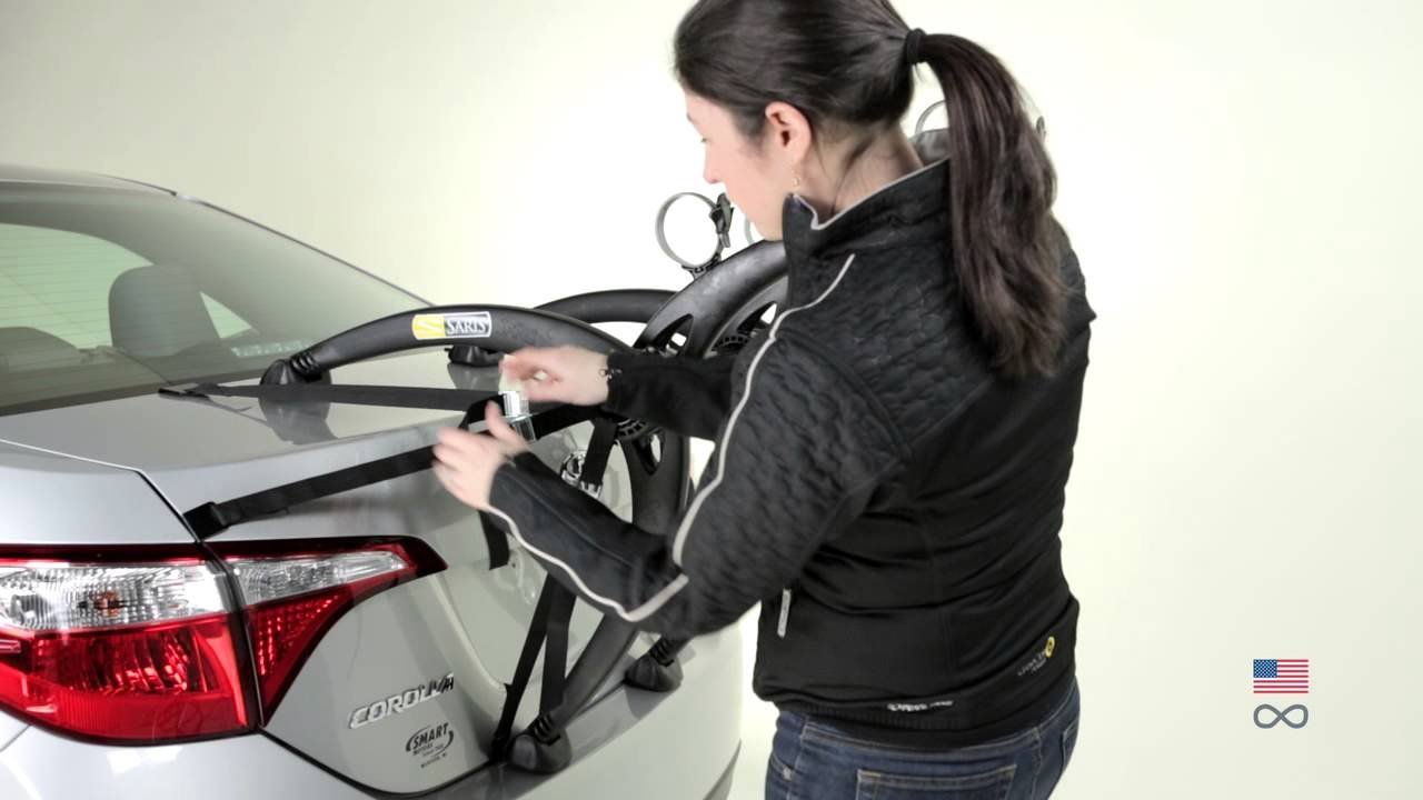 Loading a bicycle onto a Saris bike rack to illustrate common installation questions.