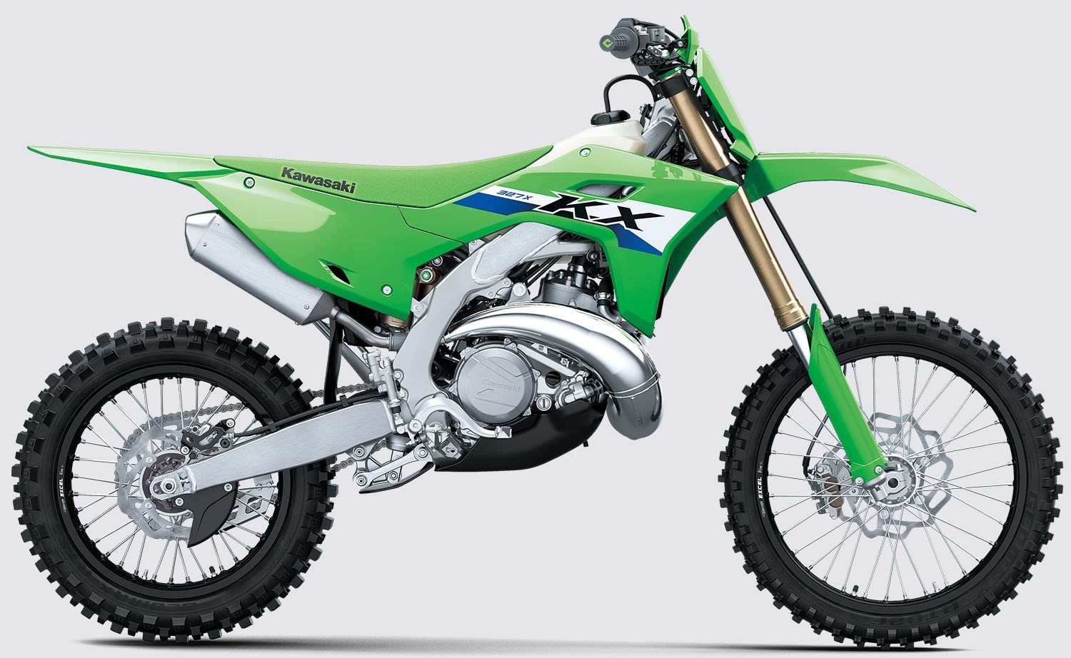Close up of a mechanic holding a small brass pilot jet for a dirt bike.