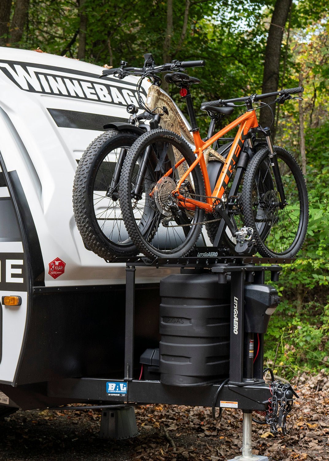 A securely mounted electric bike sitting vertically on a vehicle rack.