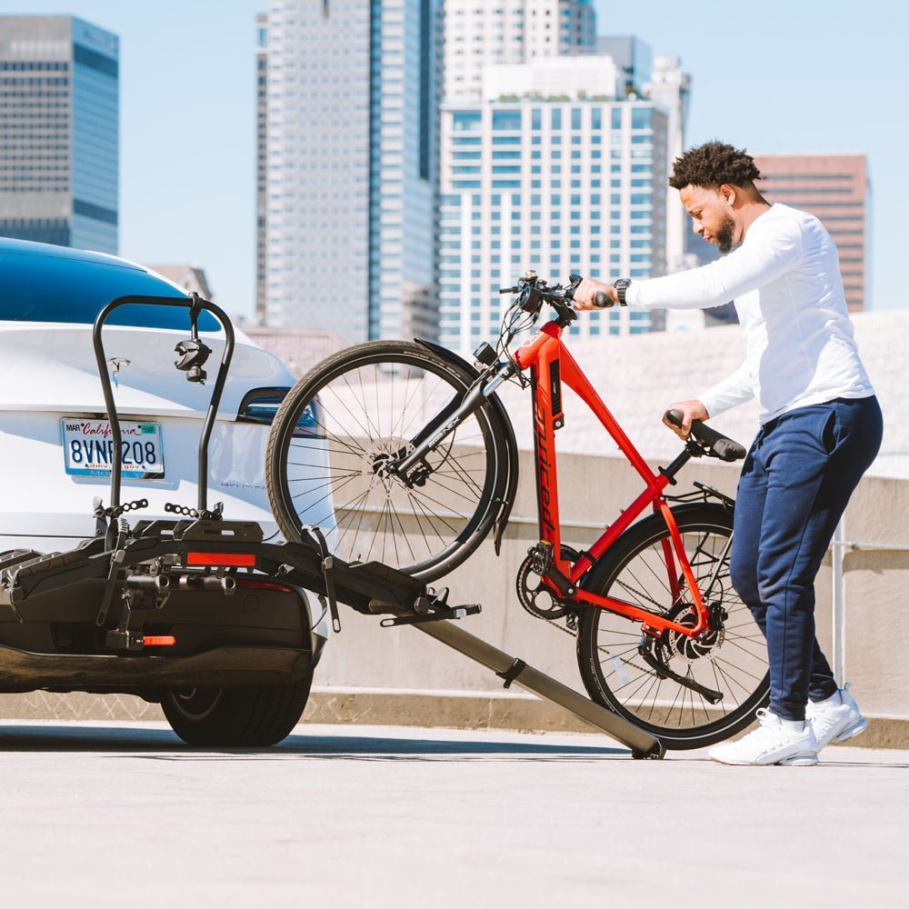 Someone checking the stability of their ebike on a rack before driving.