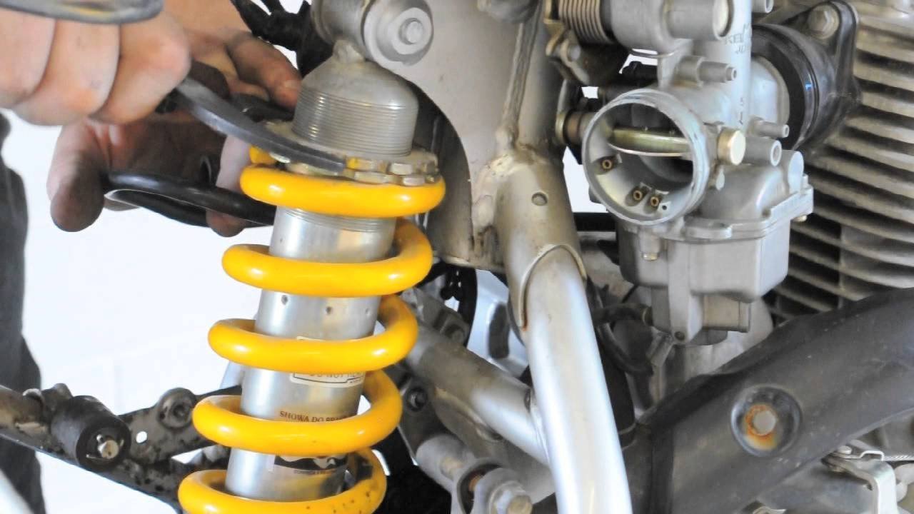 Professional tools for adjusting a dirt bike rear shock laid out neatly.