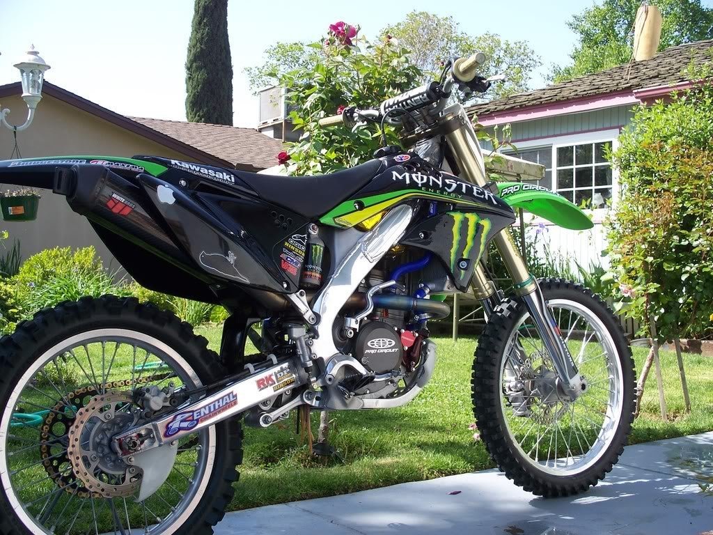Reflecting printed text on a polished dirt bike frame to check surface quality.