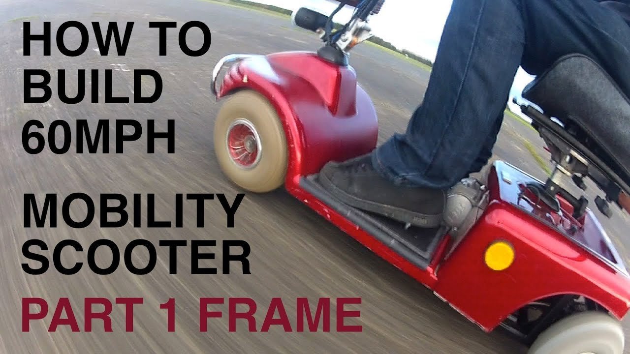 A hand turning the key on a mobility scooter to check the battery gauge.