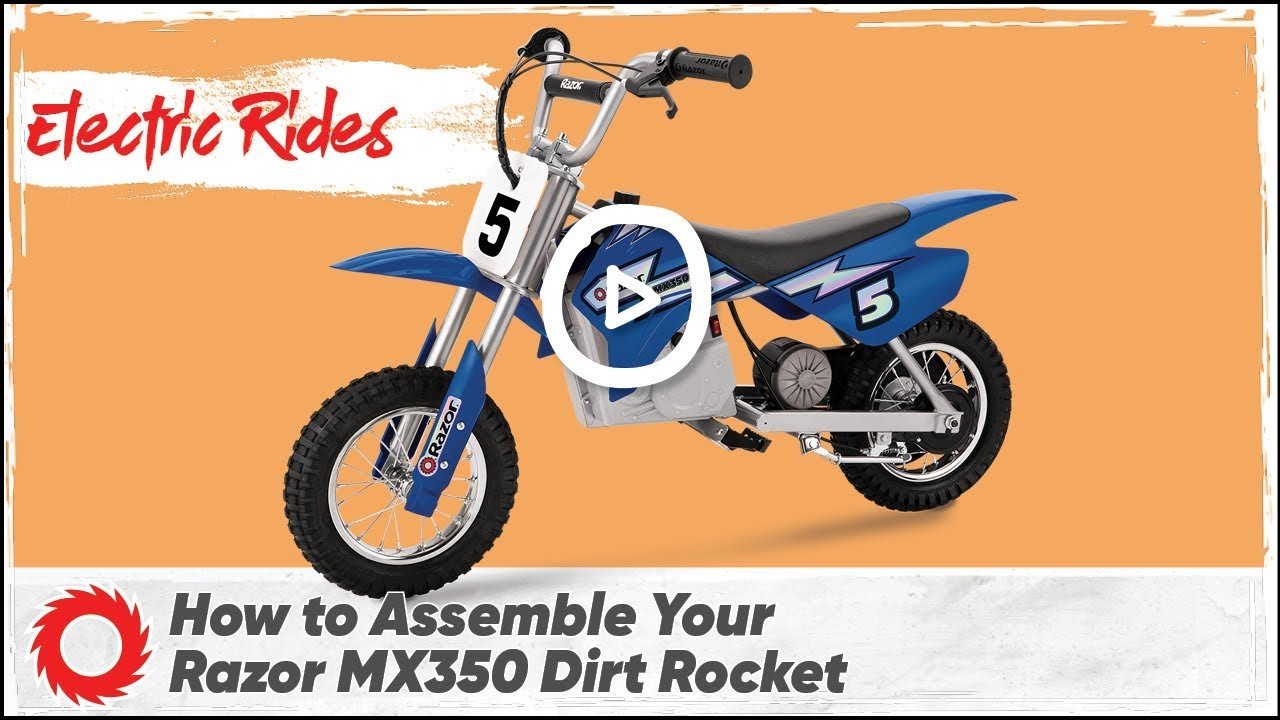 A modern electric dirt bike sits ready for action on a paved driveway.