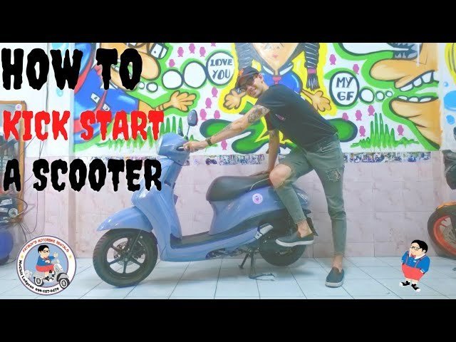 A rider checks their scooter after successfully starting the engine on pavement.